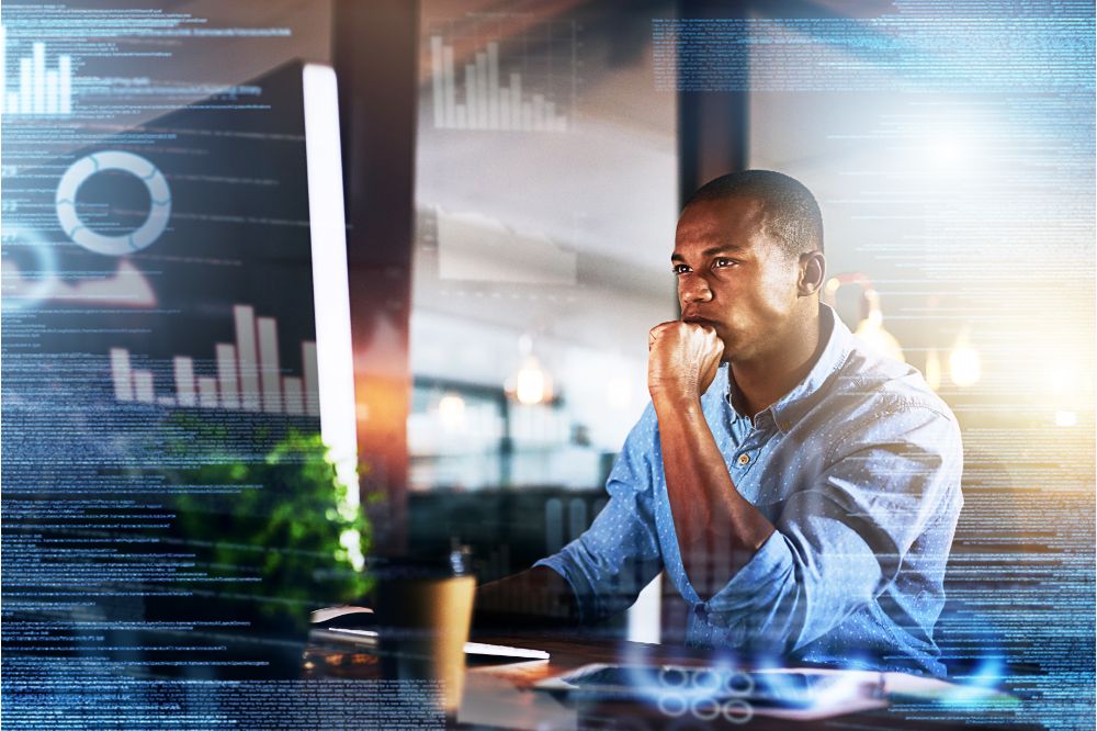  black man on computer with double exposure for finance, fintech and data analysis